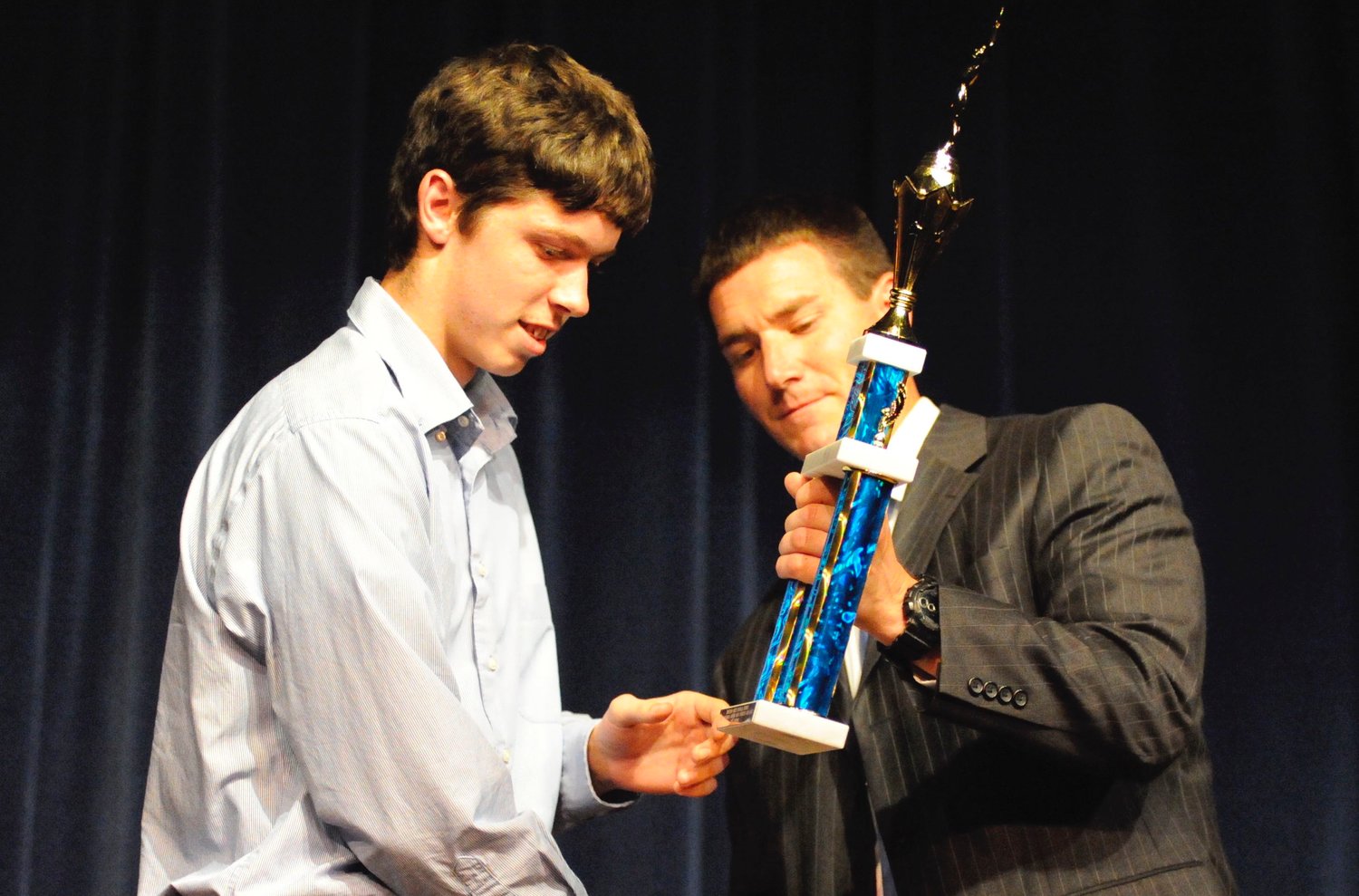 Dave Eggleton, Sullivan West’s new athletic director, presents a trophy to Kyle Reimer, one of the Bulldogs multi-sports star scholar-athletes during the spring 2019 sports awards ceremony.